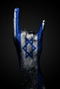 A Hand With A Drawn Israel Flag Shows A Goat Sign, A Symbol Of Mainstream, Metal And Rock Music, On A Dark Background