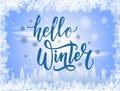 Hand drawn lettering text Hello Winter and mittens on blue background. Brush lettering on blue winter background with Royalty Free Stock Photo