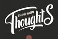 Hand drawn lettering - Think Happy Thoughts. Elegant modern handwritten calligraphy with inspiring motivation quote Royalty Free Stock Photo