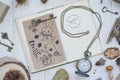 Hand drawn postcard on a craft paper on a vintage story telling book and a pocket watch QUARTZ.