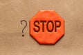 Hand drawn question mark and reflexive sign with stop text on brown paper Royalty Free Stock Photo