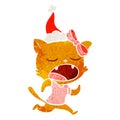 hand drawn retro cartoon of a yawning cat wearing santa hat