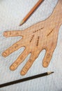 Hand drawn right hand with surgical wound suture by wooden color pencils on white paper background on table,Halloween concept. Royalty Free Stock Photo