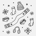 Hand drawn set of winter warm clothing items. Hat, scarf, socks, mittens and fur winter earmuffs. Vector illustration. Royalty Free Stock Photo