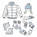 Hand drawn sketch set of winter casual warm clothes, scarf, hat, mittens, socks, boots, jacket isolated on white background. Royalty Free Stock Photo