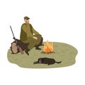 Man hunter warming up near fire with dog during hunting