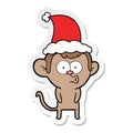 hand drawn sticker cartoon of a hooting monkey wearing santa hat