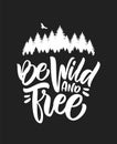 Hand drawn type lettering of Be Wild and Free with silhouette of Pine Forest and Hawk. Brush calligraphy. Royalty Free Stock Photo