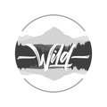 Hand drawn type lettering of Wild with silhouette of mountains lake landscape Royalty Free Stock Photo