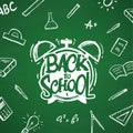 Hand drawn typographic lettering of Back to School with alarm clock and doodles supplies on blackboard background Royalty Free Stock Photo