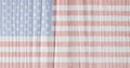 Hand-drawn U.S. national flag on old wooden surface. Light patriotic background or wallpaper. Backdrop with pale faded colors.