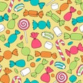 Hand drawn vector candies, canes and marshmallows seamless pattern on the yellow background.