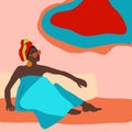 Young african woman relaxing in beach blue traditional dress.Lady with head scarf.