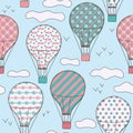 Hand drawn vector vintage seamless pattern with cute little air balloons in sky with clouds. Adventure dream background