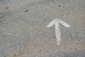 A hand-drawn white arrow on the asphalt Royalty Free Stock Photo