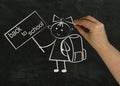 Hand draws in chalk on a black chalkboard a girl with a backpack and the inscription Royalty Free Stock Photo