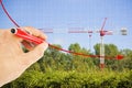 Hand draws a decreasing chart about building activity against a background with a tower crane in a construction site surrounded by