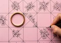 Hand drawing floral pattern on pink grid paper with a gold ring isolated on white background Royalty Free Stock Photo