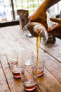 Hand drip coffee , Barista pouring coffee into cups, vintage style Royalty Free Stock Photo