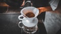 Hand Drip Coffee, Barista pouring hot water on roasted coffee ground with filter,and man is pouring hot coffee from the coffee pot Royalty Free Stock Photo