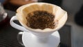 Hand Drip Coffee, Barista pouring hot water on roasted coffee ground with filter,and man is pouring hot coffee from the coffee pot Royalty Free Stock Photo