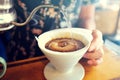 Hand Drip Coffee, Barista pouring hot water on roasted coffee ground.