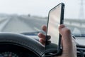 In the hand of the driver of the car, a cell mobile phone Royalty Free Stock Photo