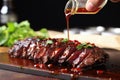 hand drizzling homemade sauce on grilled skirt steak