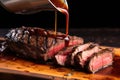 hand drizzling steak sauce over a freshly grilled steak