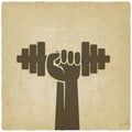 Hand with dumbbell. fitness symbol on old