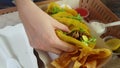 Hand eating corn tortilla carnitas taco with avocado Mexican poppular food