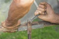 A hand of an elderly man is twisting the nut with a wrench outdoors Royalty Free Stock Photo