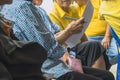 Hand of elderly woman holds a pen to prepare to take notes of local community meeting. Group taking notes while attending