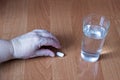 The hand of an elderly woman takes a pill, a glass of water, a close-up pill Royalty Free Stock Photo