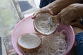 Hand of elderly woman used stainless coconut scraper for shredded coconut meat for make cooking food. Royalty Free Stock Photo