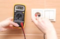 Hand electrician checking voltage Royalty Free Stock Photo