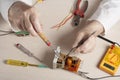 Hand of electrician with multimeter probe at electrical switchgear cabinet. Engineering tools Royalty Free Stock Photo