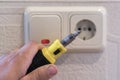 Hand Of An Electrician To Repair A Wall Socket. Closeup of man electrician's hand repairing an electrical outlet. Hazardous Royalty Free Stock Photo