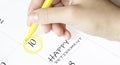 Hand encircles a date on a calendar with text Happy Retirement yellow felt-tip pen Royalty Free Stock Photo