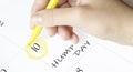 Hand encircles a date on a calendar with text Hump Day yellow felt-tip pen Royalty Free Stock Photo