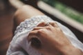 Hand with engagement ring on girl white bohemian dress on wooden porch in summer mountains. Silver ring with crystal. Girl Royalty Free Stock Photo