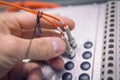 Hand of engineer inserts and connect fiber optic patch cord to industrial communication device close up. Royalty Free Stock Photo