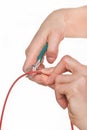 Hand of engineer with metal nippers cutting red electric cable. Technology and engineering Royalty Free Stock Photo