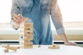 Hand of engineer playing a blocks wood tower game & x28;jenga& x29; on blu Royalty Free Stock Photo