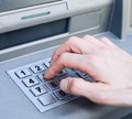 Hand entering PIN numbers on ATM bank machine Royalty Free Stock Photo