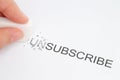 Hand erase part of the unsubscribe word Royalty Free Stock Photo