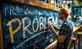 Hand erasing the word PROBLEM written in white chalk on a blackboard, symbolizing solution finding, overcoming challenges Royalty Free Stock Photo