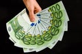 Euro currency, european uninon money, hand holding euros cash on the black background Royalty Free Stock Photo