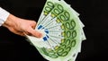 Euro currency, european uninon money, hand holding euros cash on the black background Royalty Free Stock Photo
