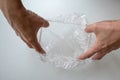 Hand expanding disposable shower cap against white background